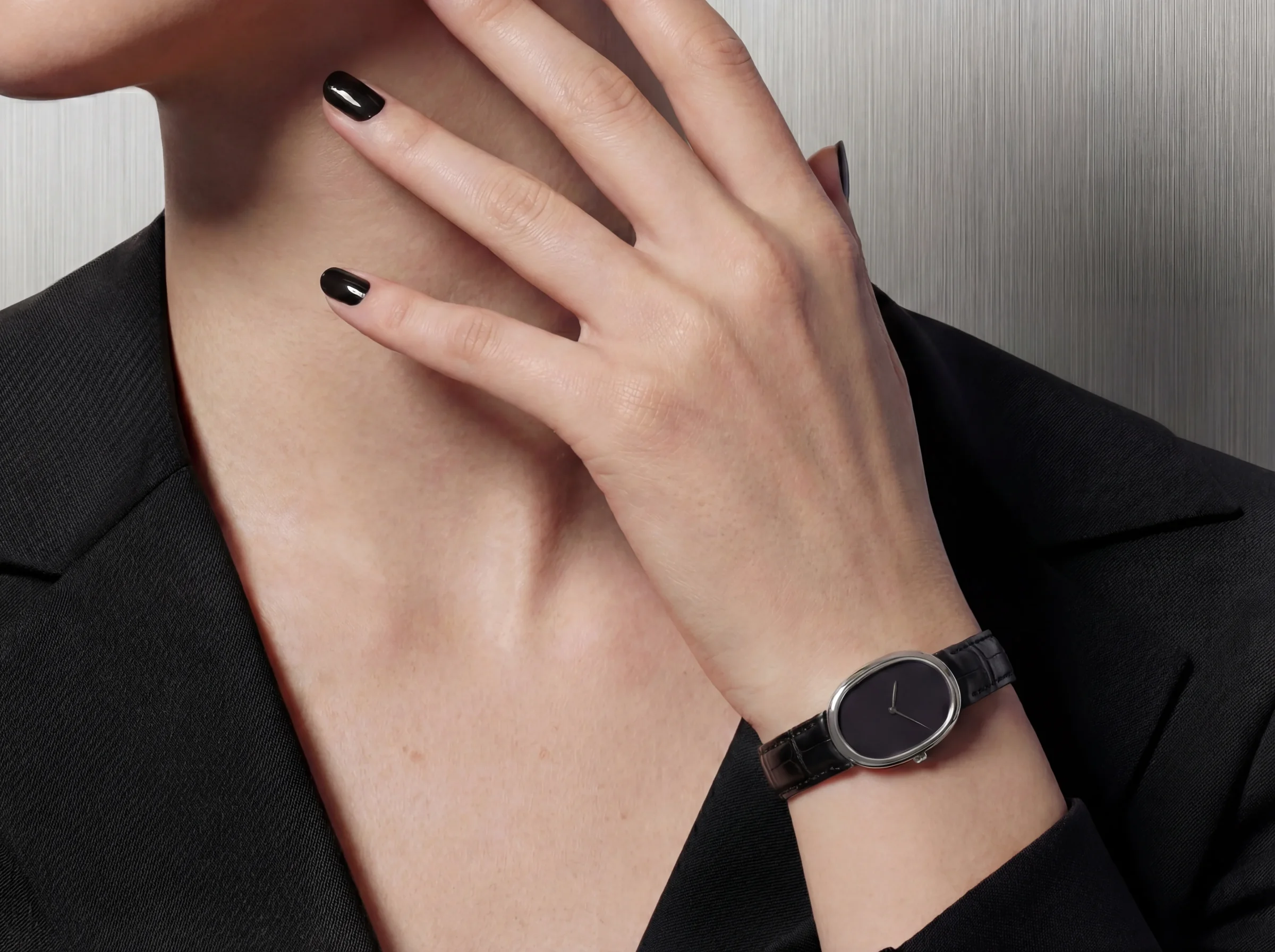 Minimal black wristwatch styled on-model in editorial crop